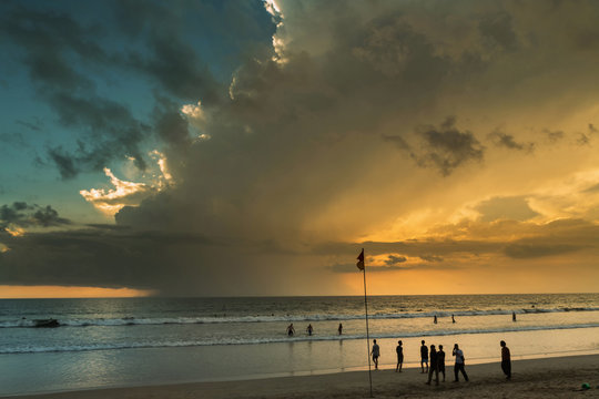 Beautiful sunset of Kuta Beach, Bali, Indonesia. Silhouettes of people at sunset on Kuta beach in Bali, Indonesia