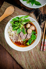 asian noodle soup with beef meatball with fresh vegetable on woo