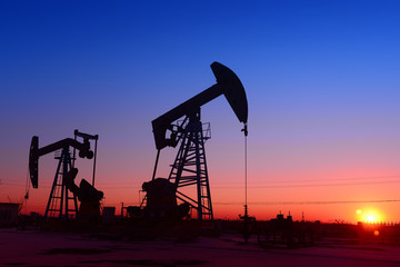 The beam pumping unit is homework, sunset in oil field