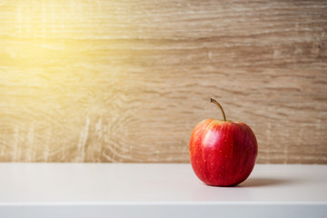 Ripe red apple on wooden background