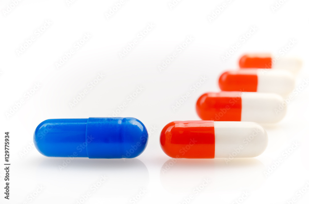 Wall mural Red and Blue Capsules on a White Background