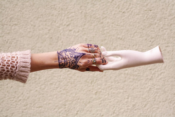 Fashionable hand with lots of rings and tattoo