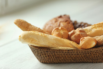 Variety of bread in a basket on a table near the window