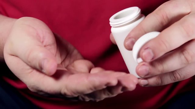 different colored pills poured on hand