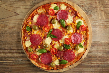 Tasty pizza on wooden table