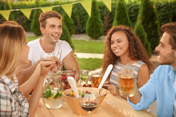 Young friends having barbecue party in garden