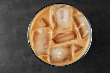 Iced coffee with milk on grey background