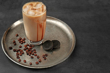 Iced coffee and cookie on silver plate