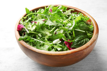 Salad mix in a bowl on wooden table