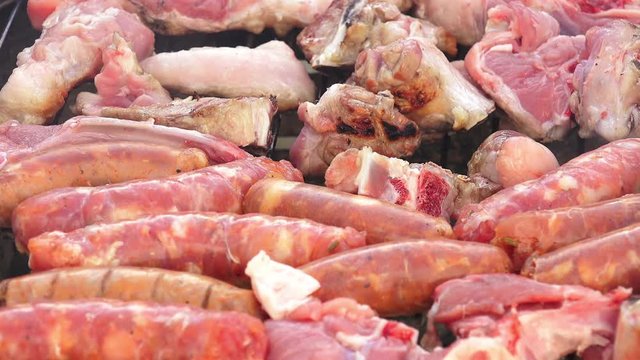 cooking meat on the barbecue: sausages, ribs, pork, beef, steaks