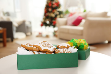 Box with tasty gingerbread cookies on blurred background