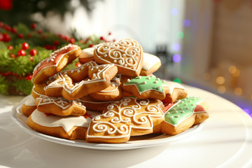 Plate with tasty gingerbread cookies on table, close up view
