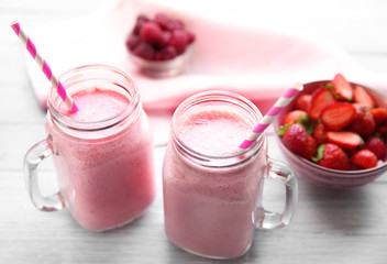 Berry milkshakes on wooden table