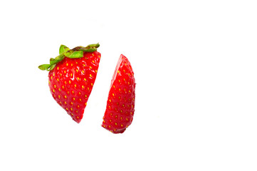 Strawberry cut in two pieces isolated on a white background
