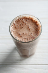 Delicious milkshake on wooden background