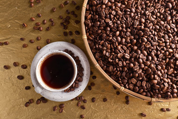 Cup of black coffee and roasted beans