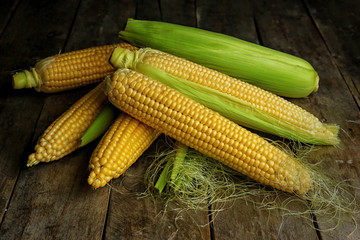 Ripe corns on wooden background