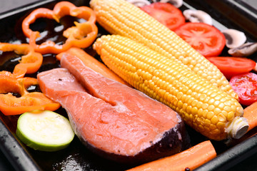 Slice of red fish and vegetables, closeup