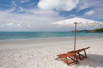 Beach chairs on the white sand beach.