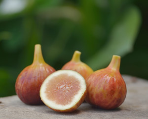 Fresh figs, sweet figs isolated on wooden background.