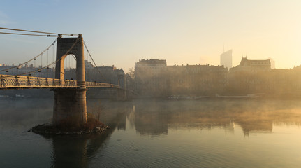 Fototapeta premium Fog over the Rhone river in Lyon during an autumn sunrise.