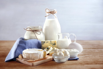 Fresh dairy products and napkin on table and light background