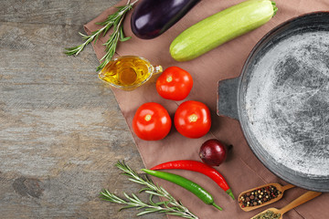 Pan with vegetables and spices on table