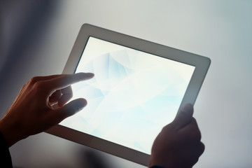 Businessman touching screen of modern tablet, closeup