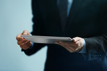Businessman holding modern tablet, closeup