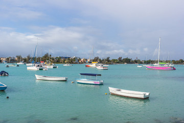 Fototapeta na wymiar Fishing boats on the water at Grand Baie in Mauritius