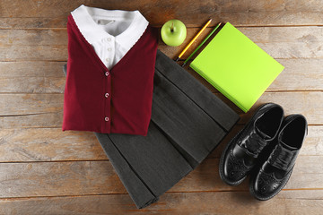 School uniform on wooden background
