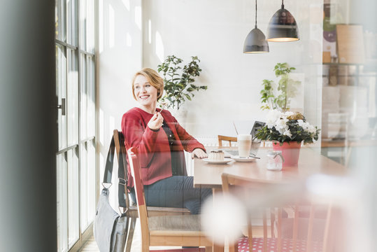 Smiling young woman in a cafe