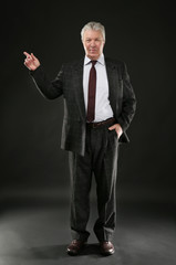 Senior businessman on black background