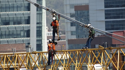 Engineers installing tower crane in Chile