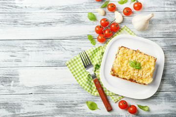 Homemade meat lasagna on wooden table