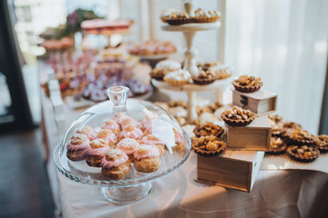 Naklejka na ściany i meble sweet bar with muffins cakes and sweets in area of wedding party