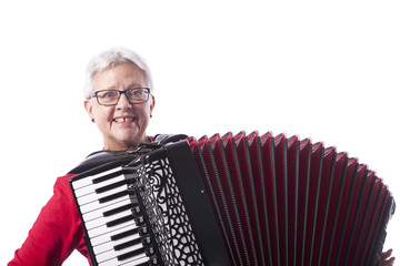 older woman plays accordion in studio with white background