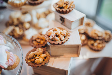 sweet bar with muffins cakes and sweets in area of wedding party