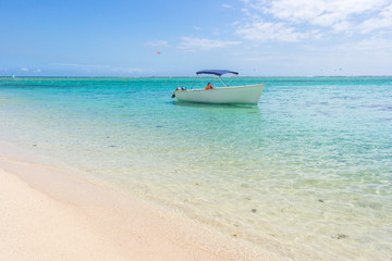 Alone boat on Idyllic beach on the coast of Mauritius