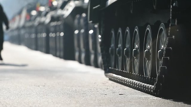 Detail shot with green tank tracks and wheels during military parade