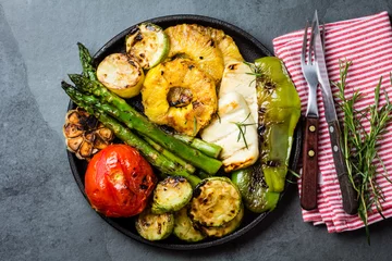 Fototapeten Grilled vegetables, pineapple slices and fresh cheese on iron plate © lblinova