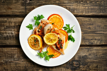 Grilled chicken breast with orange sauce, top view