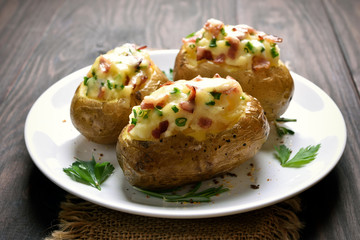 Baked potato with bacon, cheese and green onion