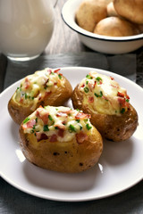 Stuffed potato with bacon, cheese and green onion