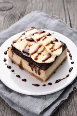 Cheese cake with chocolate syrup and piece of banana
