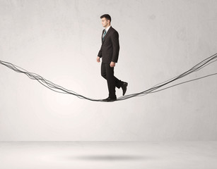 Sales person balancing on drawn ropes