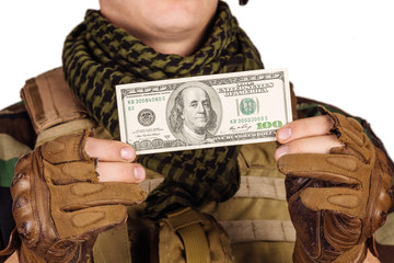 soldier holding money against white background with cash.
