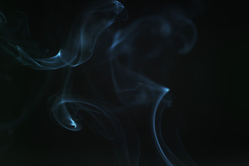 real blue smoke over black background, abstract backdrop