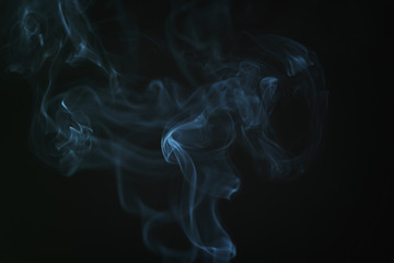 real blue smoke over black background, abstract backdrop