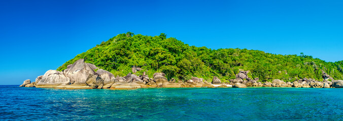 Fototapeta premium Water excursion to the Similan Island, Andaman Sea, Thailand. Beautiful landscape with the rock, white sand beach and dense tropical forest.